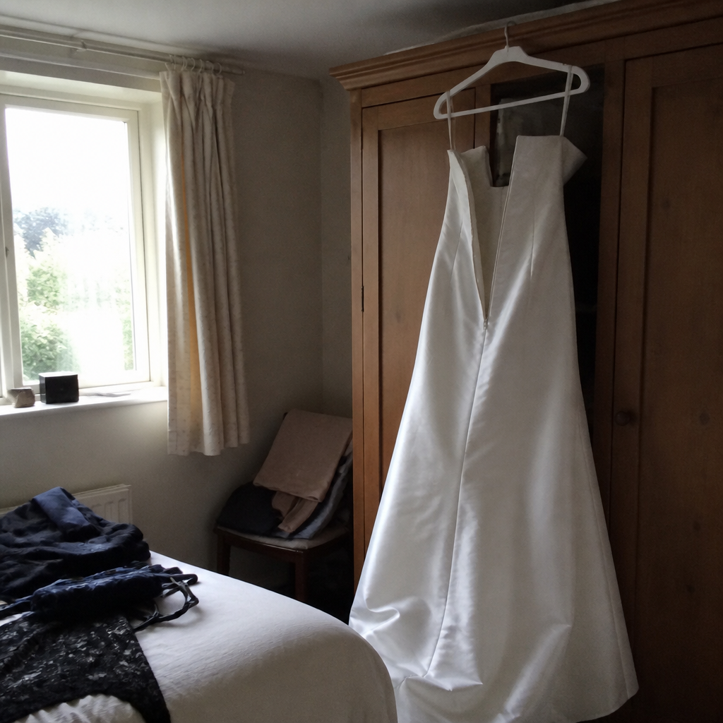 A wedding dress on a hanger with the zip undone